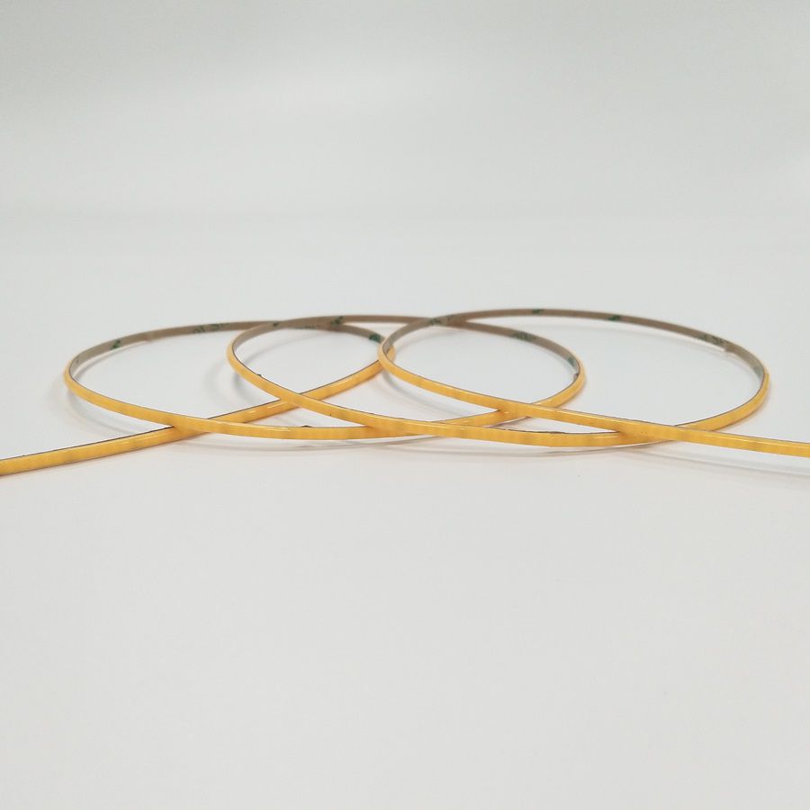 Ultra-narrow COB LED strips arranged in loops on a white background
